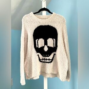 White fluffy sweater with black skull. Size Large